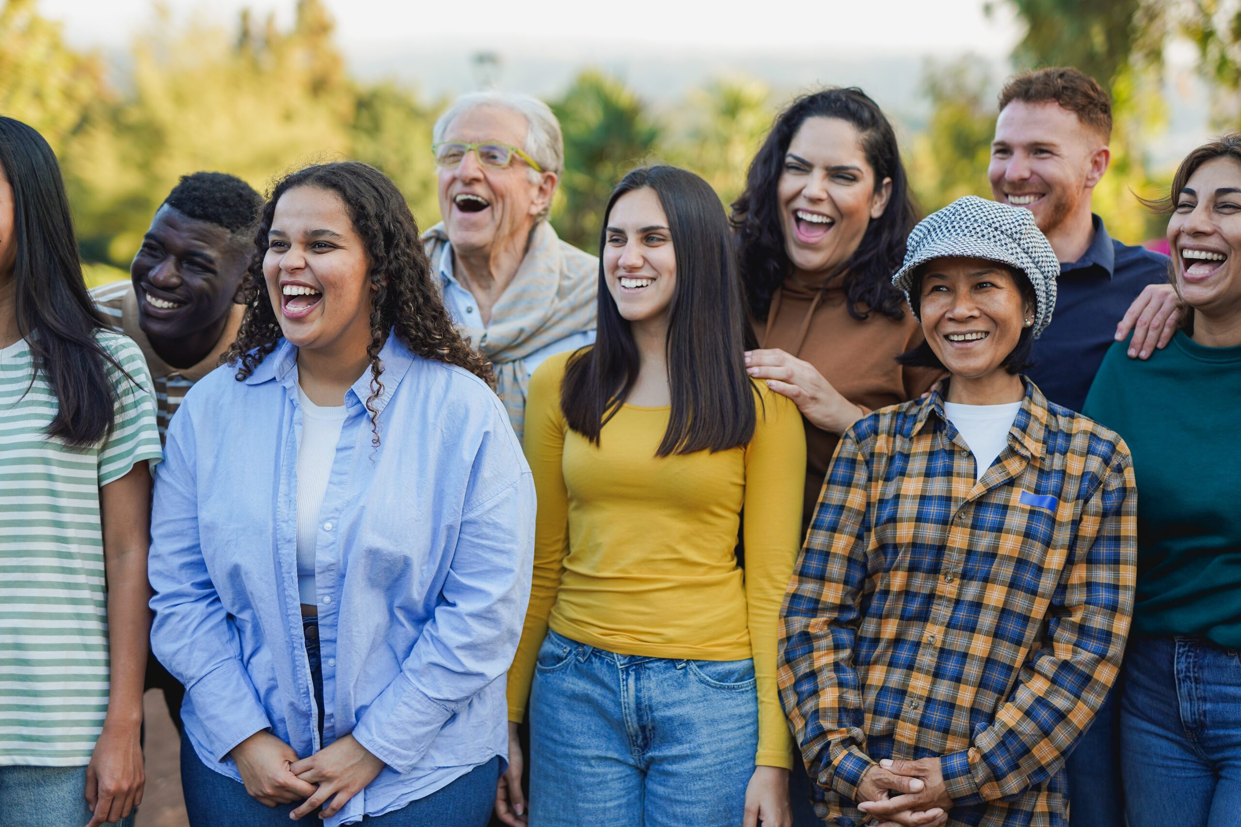 Crowd of multi generational people having fun together outdoor -